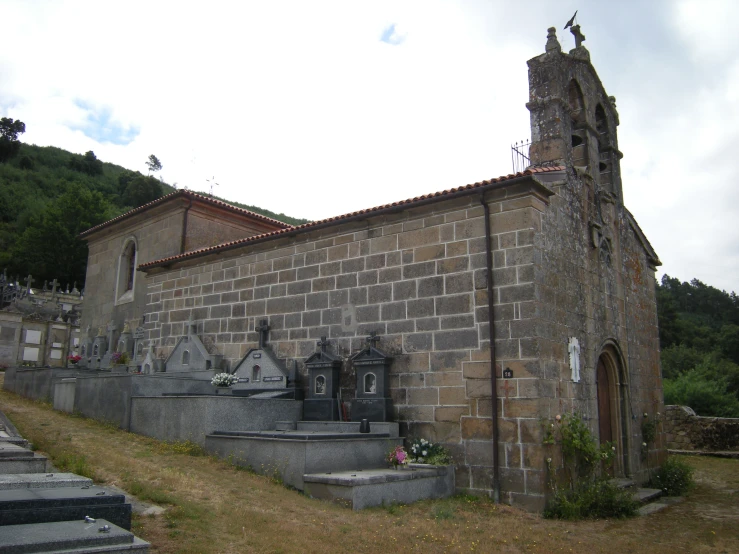 a small cemetery sitting on the side of a hill