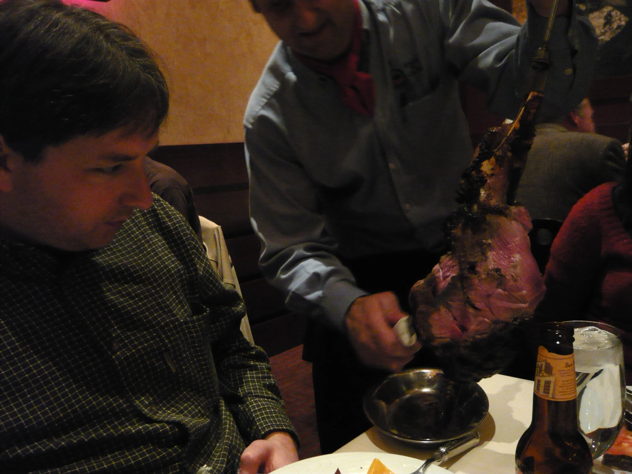 a man is peeling some meat from the table