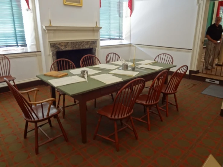 a dining room is set with empty place settings for dinner