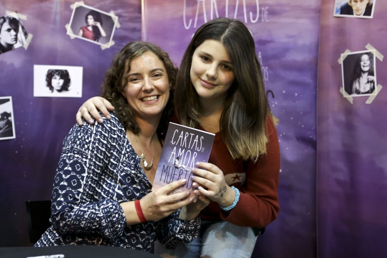 two women pose with one another for a po