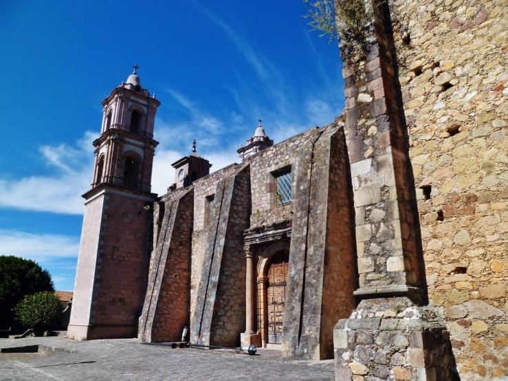 an old, worn out building with a tower and large clock tower