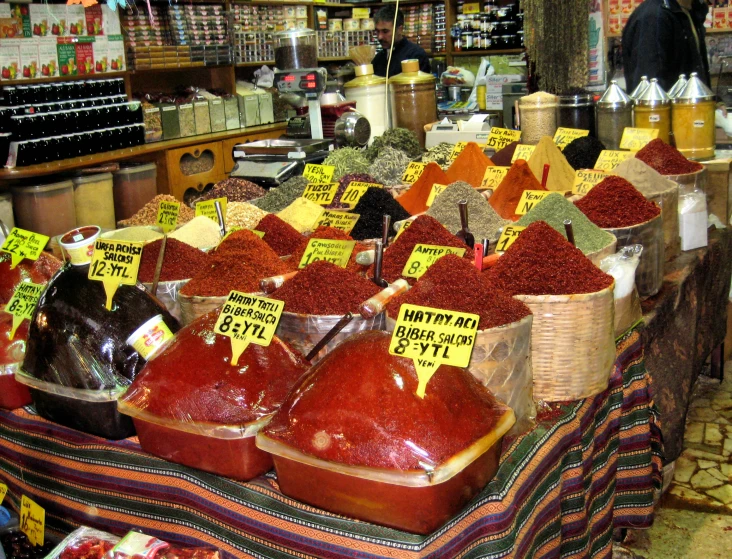 a large assortment of spices sitting on top of a counter