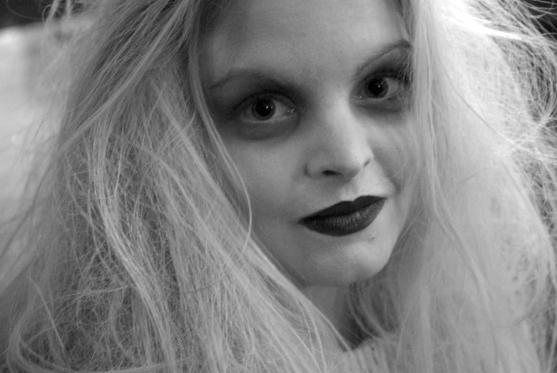 black and white image of a creepy woman with long blonde hair