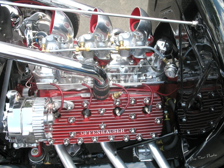a red and black engine is showing the components inside