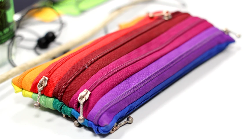 a colorful wallet case and some other items are on a table