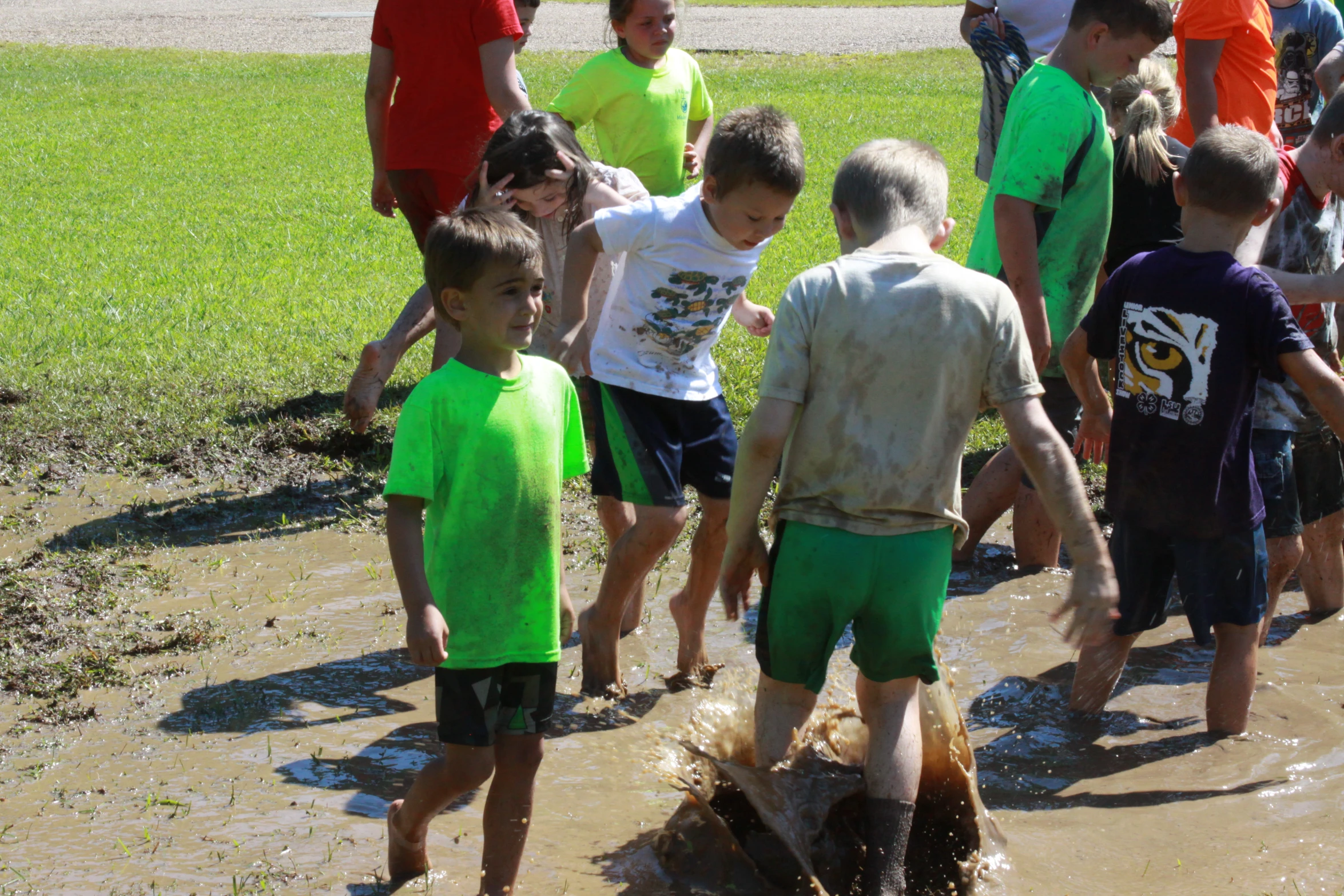 there is a group of young children playing in the mud