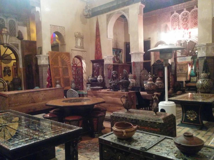 an arabic sitting area with two tables and one table is empty