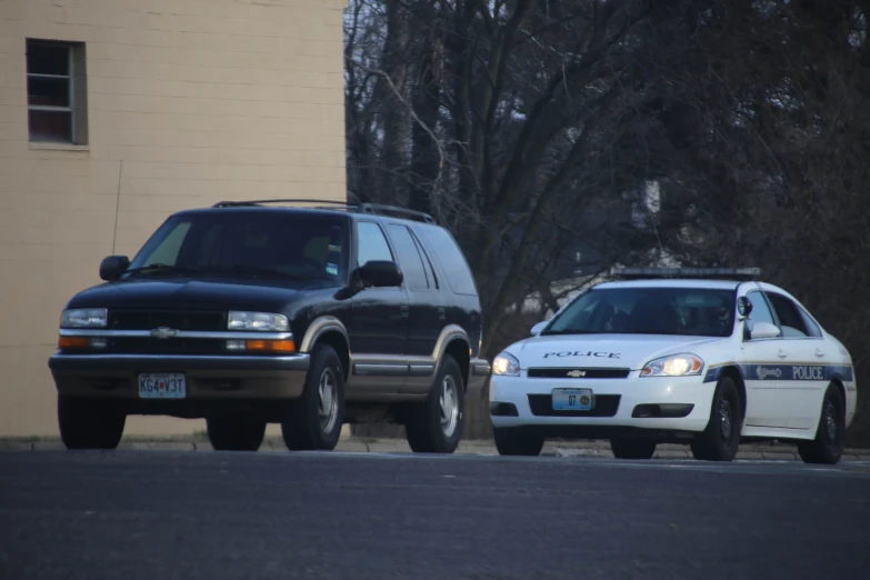 two police cars parked in front of a building