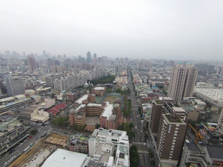 aerial view of city from observation point of building on gray sky