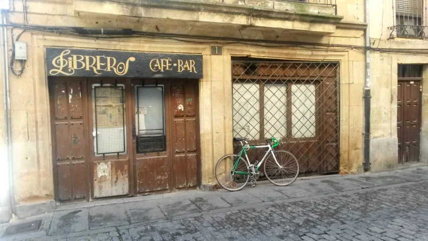 a bicycle parked in front of an empty restaurant