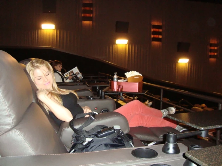 a lady in the movie theater waiting for her seat