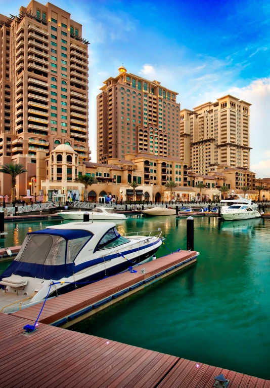a boat floating on a body of water next to large buildings