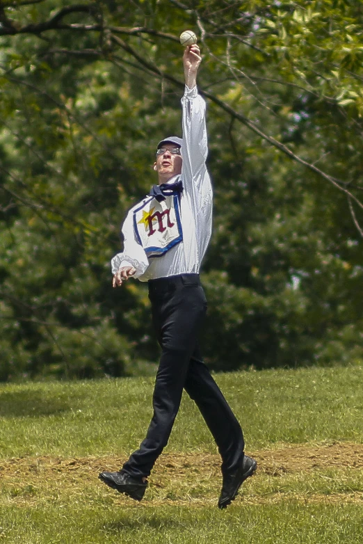 a man in a bow tie is playing baseball