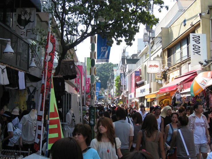 many people are walking down a busy street