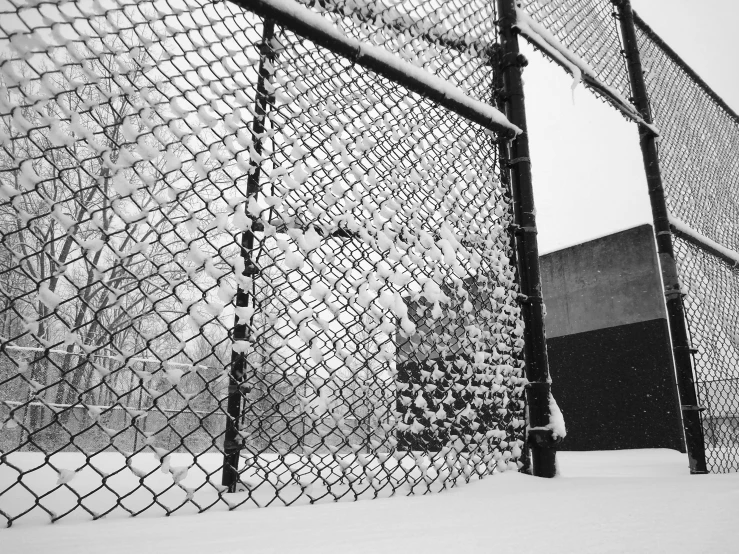 there is a piece of metal fence that has a snow bank on it