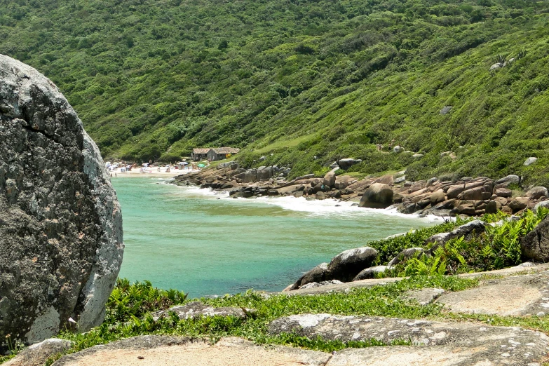 rocks are on the hillside side next to the ocean