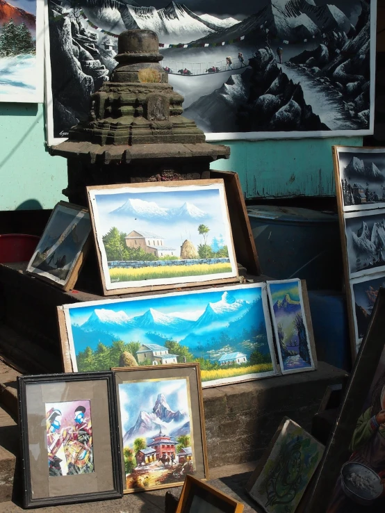 some pictures and art on display in front of a building