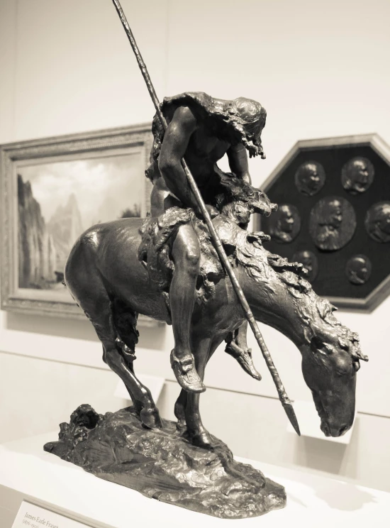 a statue of a man riding a horse with a sword