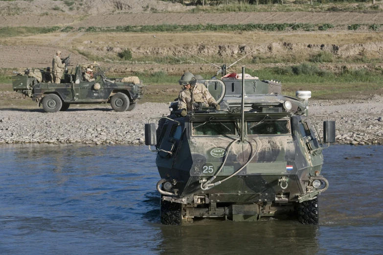 a couple of soldiers driving onto a road