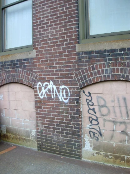 a street side with a graffiti on the side
