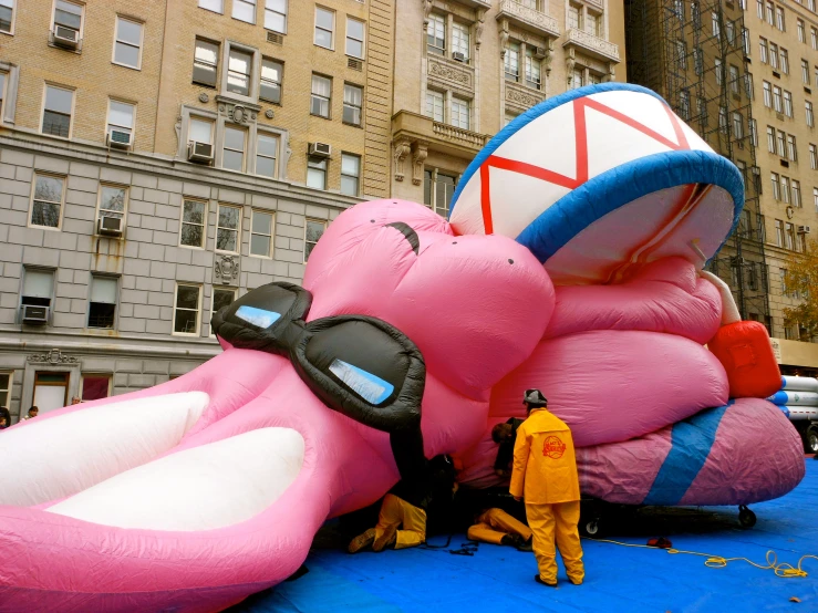 a inflatable float with a giant pink bird in a parking lot