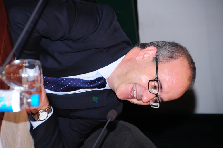 a man wearing glasses and sitting at a table