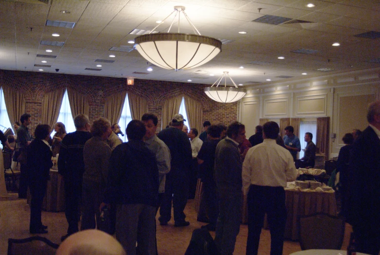 a room filled with people talking and sitting