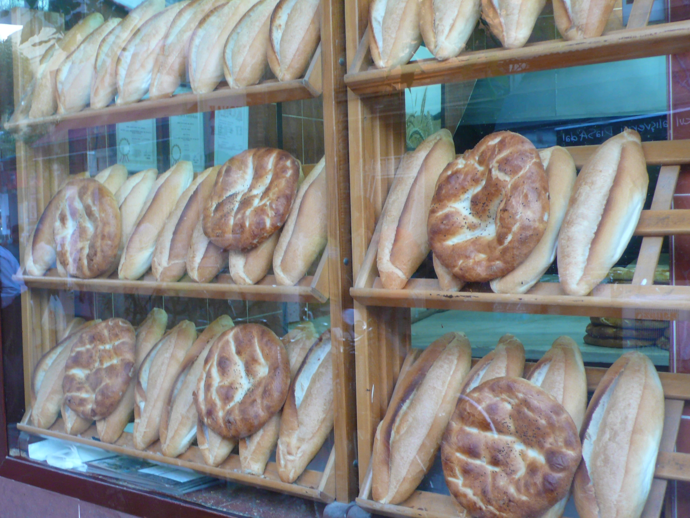 breads are stacked and ready in the store window