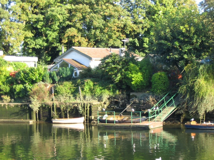 an island with houses sitting on the edge of it, and water and a small boat floating on it