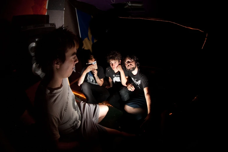 a group of young people sitting together next to each other