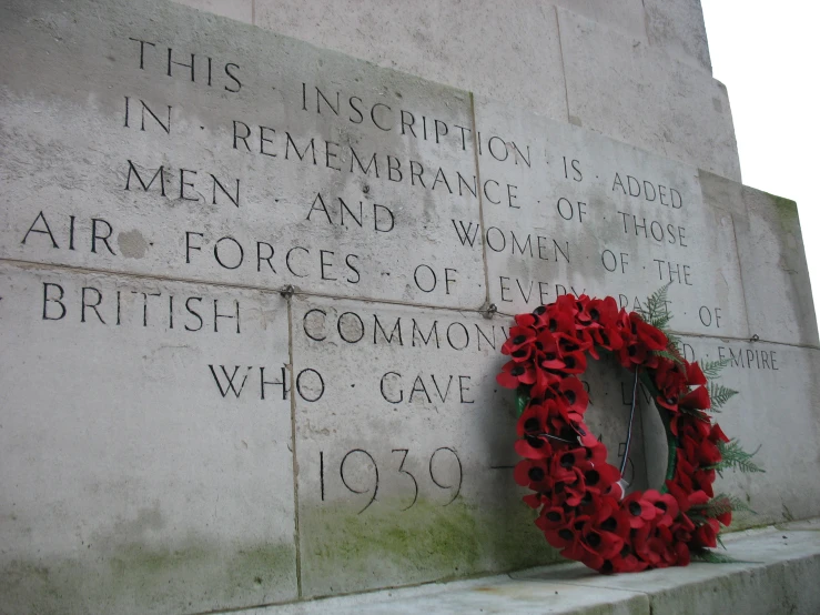a wreath placed on the wall next to a wreath with writing on it