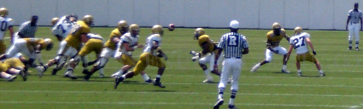 several football players run on a field together