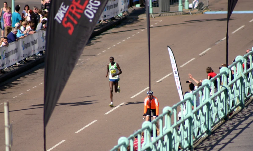 a runner crosses the finish line at a marathon