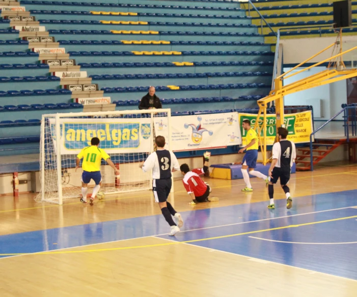 the boys are playing a game of volleyball