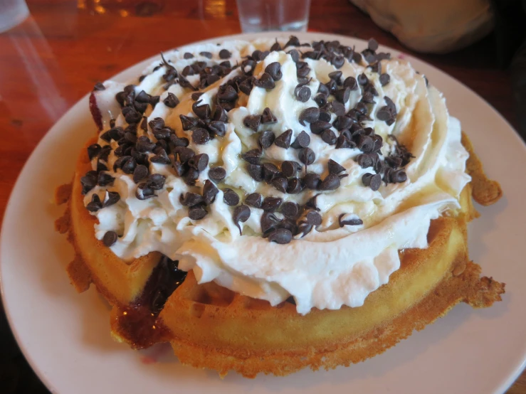 a waffle topped with cream and chocolate chips