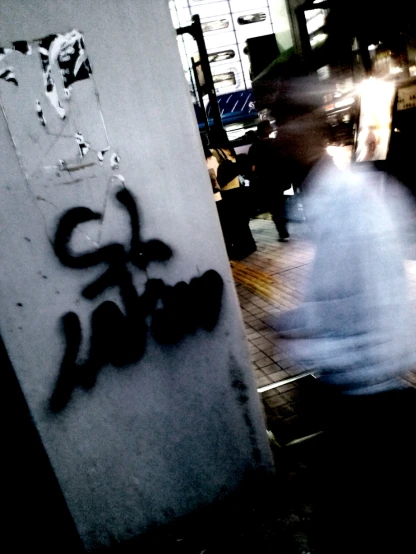 a man walks past graffiti that reads don't stop at the subway