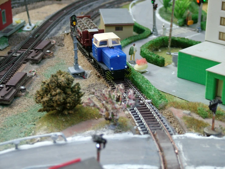 a toy model train is moving along on tracks