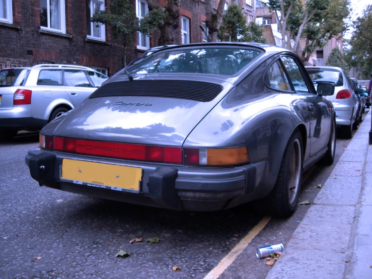 a silver porsche on the side of the road