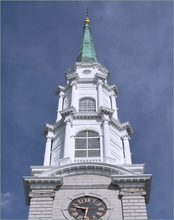 the tall tower on top of the building has a clock in it