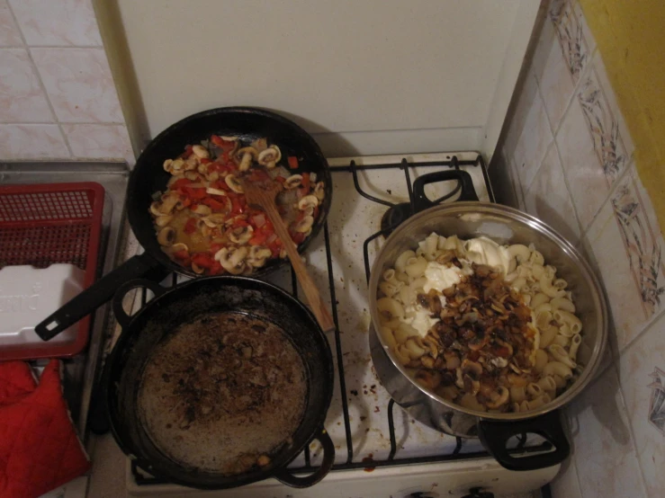 the three cooking pots are full of food