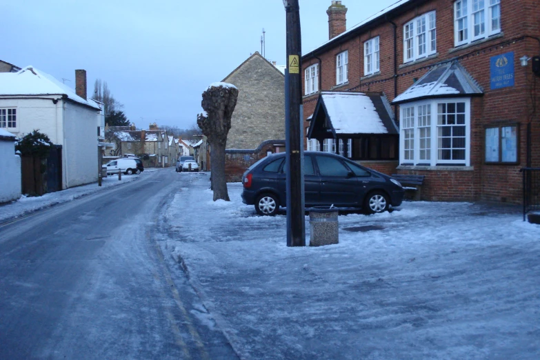 a car driving through the snow covered road