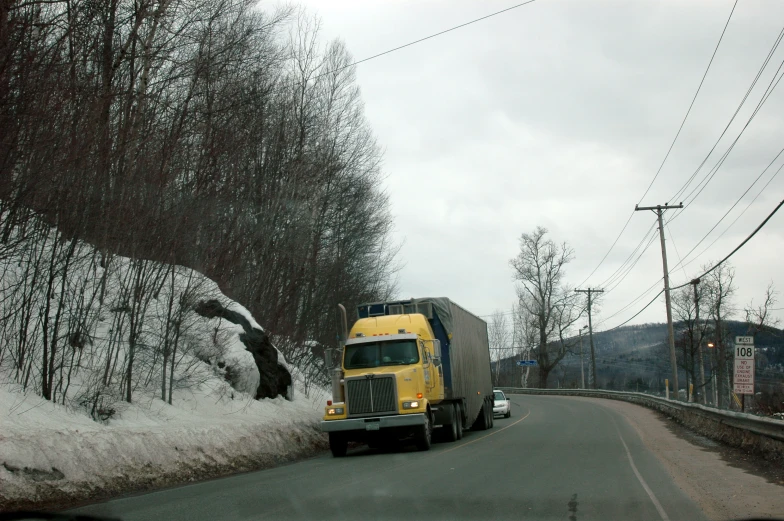 the truck is driving on the snowy road