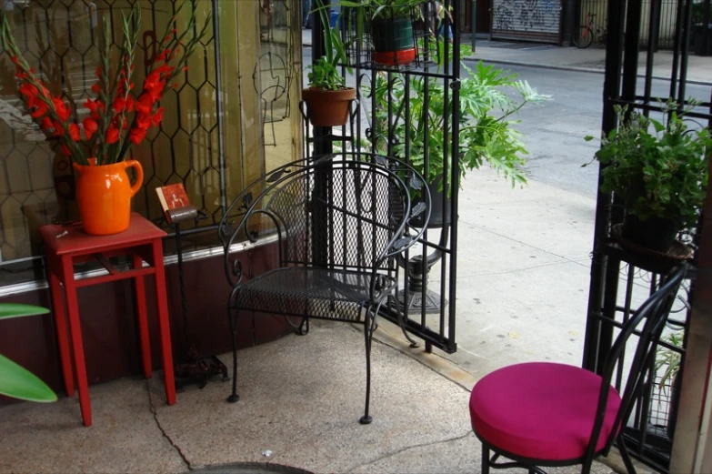 the patio of a restaurant has two small tables and chairs