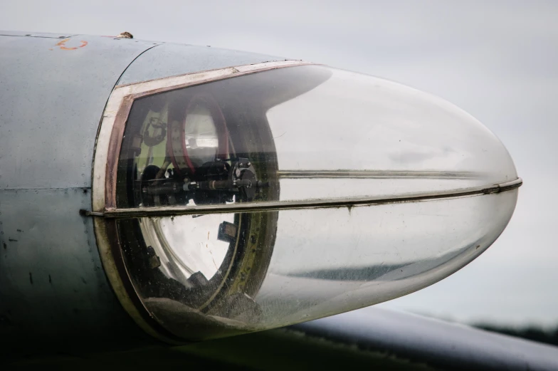 a reflection of a man sitting inside the window of an airplane