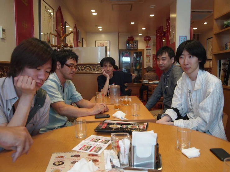 group of asian people gathered at an asian restaurant