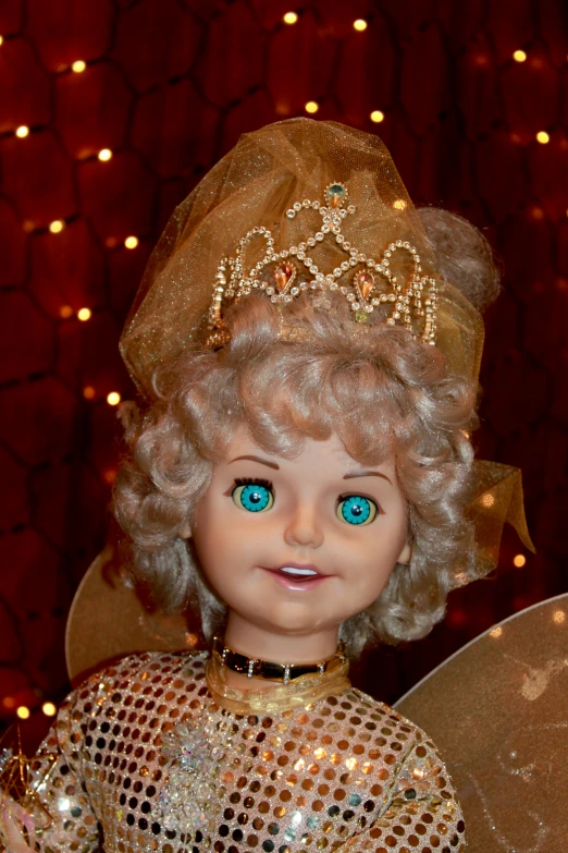 an angel doll with gold and blue eyes