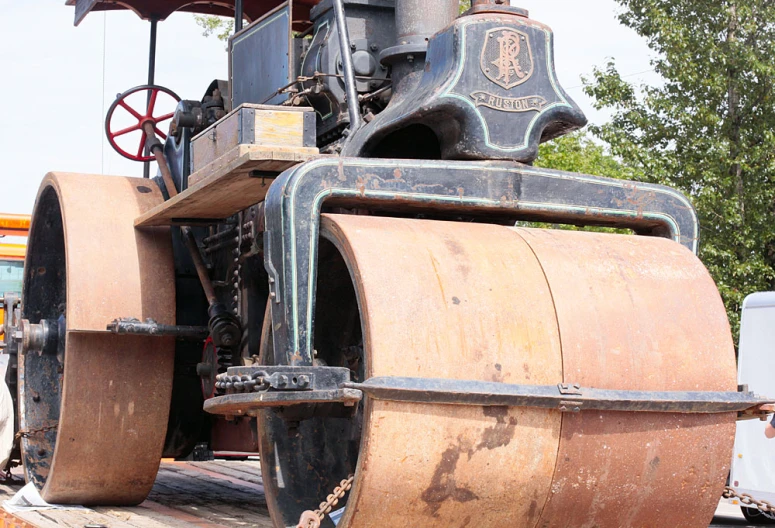 a locomotive traveling through the woods on a sunny day