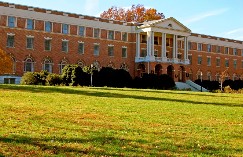 a large building is shown from across the field