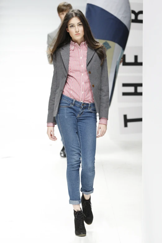 the model wears a grey jacket and pink top