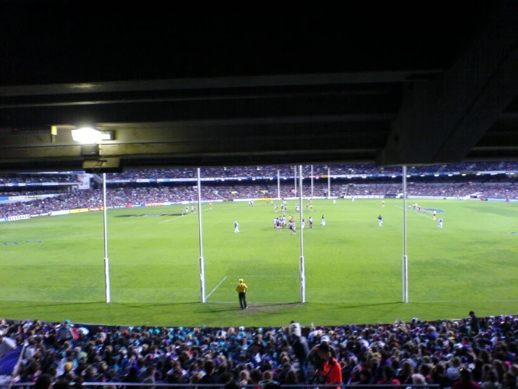 a soccer game in the middle of a stadium full of people